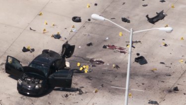 An aerial view shows the car that was used the previous night by two gunmen, who were killed by police, as it is investigated by local police and the FBI in Garland, Texas May 4, 2015. Texas police shot dead two gunmen who opened fire on Sunday outside an exhibit of caricatures of the Prophet Mohammad that was organized by a group described as anti-Islamic and billed as a free-speech event. REUTERS/Rex Curry