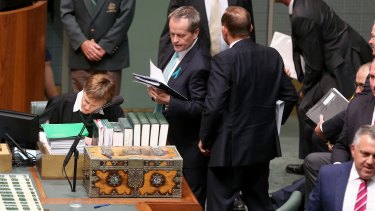 Opposition leader Bill Shorten tries to squeeze past Prime Minister Tony Abbott after a division in question time on Wednesday.