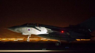 In this image released by Britain's Ministry of Defense, an RAF Tornado comes into land at Britain Royal Air Force base in Akrotiri, Cyprus, after its mission to conduct strikes in support of operations over the Middle East.