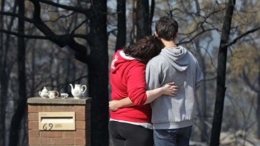Amy Hubbard with her partner Adam Ilhan out the front of her home in Buena Vista Road, Winmalee, which was destroyed in the Blue Mountains fire.