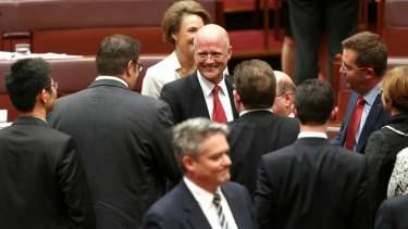 LDP Senator David Leyonhjelm is congratulated by PUP Senator Glenn Lazarus after delivering his maiden speech. Photo: Alex Ellinghausen