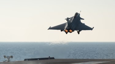 A French army Rafale fighter jet taking off from the deck of France's aircraft carrier Charles De Gaulle, in the Mediterranean sea. The French Defence Ministry says it has launched its first airstrikes from the carrier , bombing Islamic State targets in the Iraqi cities of Ramadi and Mosul. 