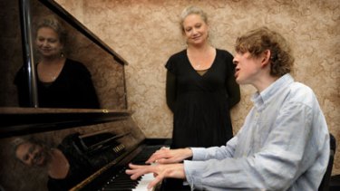 Rory Burnside plays the piano with his mother Deb Duncan by his side.