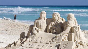 Urgent plea ... a sand sculpture made by activists from charity group Oxfam in Cancun, Mexico, the host city for the latest climate talks.