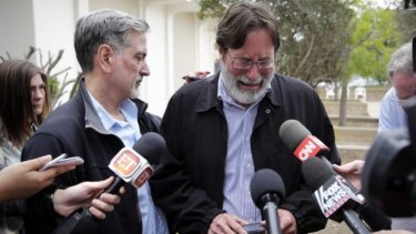 "When will this insanity stop?" Richard Martinez, right, who says his son Christopher was killed in Friday night's mass shooting, is comforted by his brother, Alan, as he talks to media outside the Santa Barbara County Sheriff's headquarters.