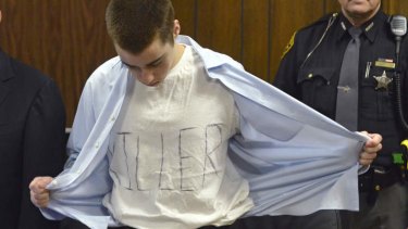 Defiant ... TJ Lane unbuttons his shirt during sentencing.