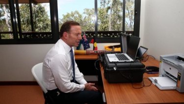 Prime Minister Tony Abbott speaks with ASIO Director-General Duncan Lewis via a secure tele-conference from Arnhem Land.