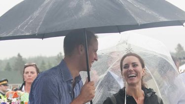 Prince William, Duke of Cambridge and Catherine, Duchess of Cambridge have a walkabout in the rain.