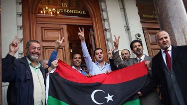People celebrate outside the Libyan embassy in Knightsbridge, London.