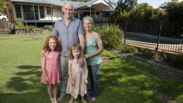 Belinda Kerr at home on Queensland's sunshine coast with husband Michael Trehy and daughters Molly, left, and Ivy.