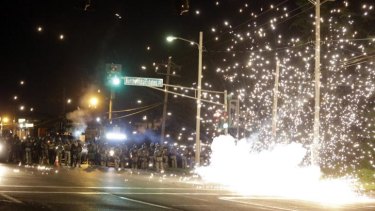 A device deployed by police goes off in the street as police and protesters clash on Wednesday night.