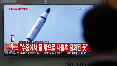 A South Korean man watches TV news footage of a missile launch conducted by North Korea in April.