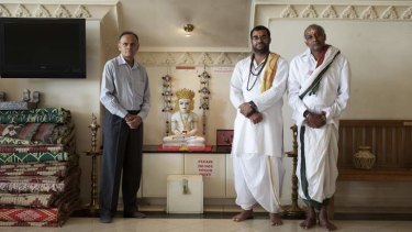 Manoj Doshi with two priests at the multi-faith temple in Minto.