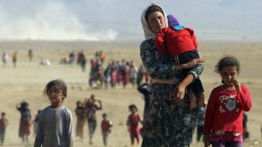 Displaced people from the minority Yazidi sect flee violence from forces loyal to the Islamic State in Iraq's north.