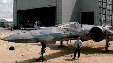 Practically perfect: JJ Abrams stands in front of a starfighter, possibly an X-Wing, built for his <i>Star Wars: Episode VII</i>.