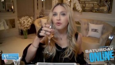 Madonna takes a refreshment break while answering questions in her 20 minute Saturday Night Online with Romeo fan Q&A.