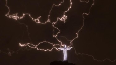 Lightning flashes over the statue of Christ the Redeemer on top of the Corcovado mountain in Rio de Janeiro, Brazil.