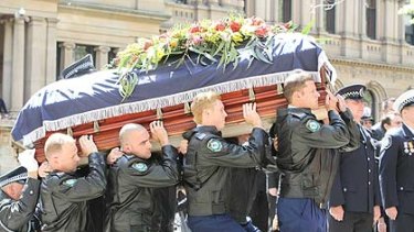 Officers carry the coffin into the cathedral.
