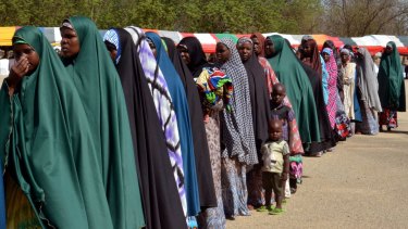 Women and children, who were being detained on suspicion of affiliation to Boko Haram, line up as they are released by the Nigerian military in Maiduguri, Nigeria.