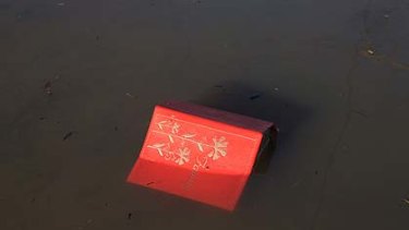 A family photo album sits in flood water.