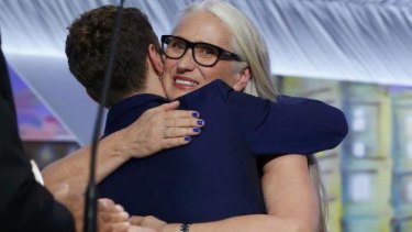 Jury president Jane Campion hugs director Xavier Dolan during the closing ceremony of the 67th Cannes Film Festival.