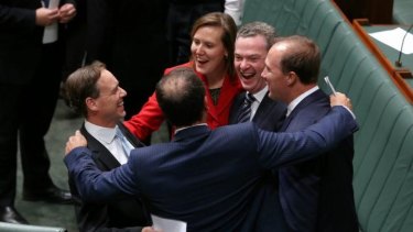 Environment Minister Greg Hunt is congratulated by colleagues after Carbon Tax Repeal Bills pass the Lower House. The Anglican Church has called on the Abbott government to change its policies on climate change.