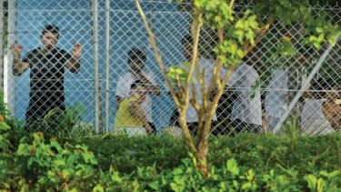 Asylum seekers behind the wire of the Manus Island detention centre.