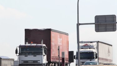 Trucks coming down M5 East ramp, heading for Port Botany. The government remains without a concrete plan to connect WestConnex to Sydney Airport or Port Botany.