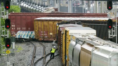 An emergency personnel employee works at the scene after a CSX freight train derailed in Washington.