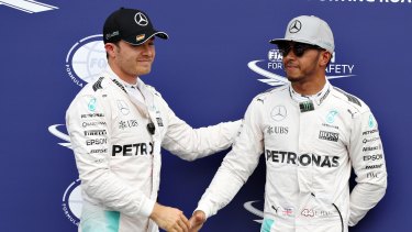 HOCKENHEIM, GERMANY - JULY 30: Nico Rosberg of Germany and Mercedes GP and Lewis Hamilton of Great Britain and Mercedes GP shake hands in parc ferme after qualifying for the Formula One Grand Prix of Germany at Hockenheimring on July 30, 2016 in Hockenheim, Germany. (Photo by Mark Thompson/Getty Images)