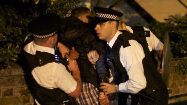 Dysfunction ... a youth is arrested by British police officers in Camden, north London.