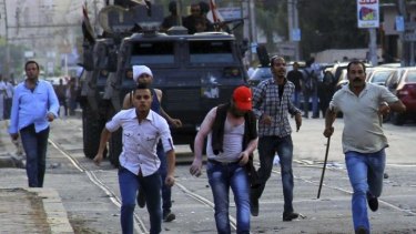 Armoured police vehicles advance on protesters during a rally against anti-protest legislation in Cairo on Saturday.