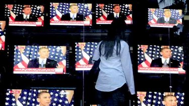 An Egyptian woman watches Mr Obama's address in Cairo.
