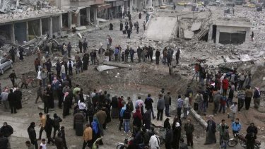 Residents inspect a huge hole in the ground at a site hit by what activists say was a Scud missile from forces loyal to Syria's President Bashar al-Assad.