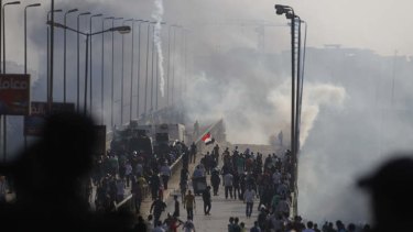 Members of the Muslim Brotherhood and supporters of ousted Egyptian President Mohamed Mursi flee from tear gas and rubber bullets fired by riot police during clashes in Cairo.