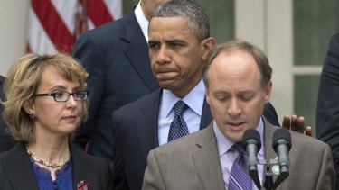 President Barack Obama, flanked by shooting victim Gabby Giffords, left, and Mark Barden, the father of Newtown shooting victim Daniel, following the defeat of new gun control measures in the US Senate.