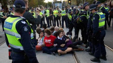 Teenage students sat on tram tracks on Spring Street during the heated protest.