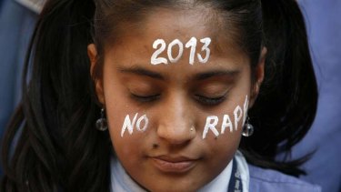 A student prays in Ahmedabad during a vigil for a gang rape victim, who was assaulted in New Delhi, December 31, 2012.