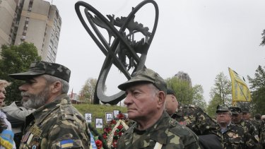 Chernobyl veterans commemorate victims of the Chernobyl nuclear disaster at a memorial in Ukraine's capital Kiev.