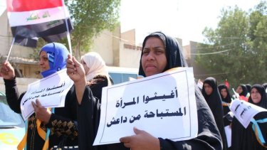 Iraqi women in the southern city of Basra hold placards protesting the abuse of women by Islamic State militants.