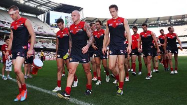 A familiar sight: Daniel Cross, Nathan Jones and Jack Grimes of the Demons lead the team back to the rooms after a big loss to the Eagles.