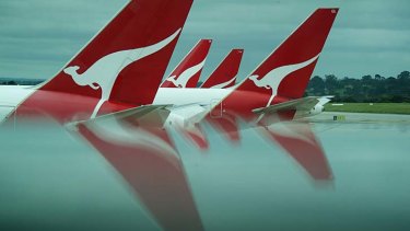 Qantas blames industrial action and high fuel costs for its profit slump.