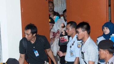 Convicted Australian drug smuggler Schapelle Corby leaves the parole office in Denpasar after signing papers before being deported back to Australia. 