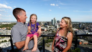 Marton Sadler with his wife Agata and child Olivia in their Southbank high-rise apartment.