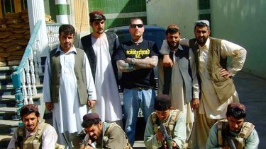 Kenneth Stewart surrounded by Afghans.