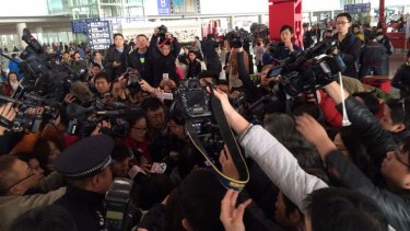 Reporters interview relatives at Beijing Capital International Airport.