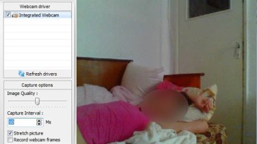 An image uploaded to a hacking forum showing a woman sleeping as seen through her webcam.