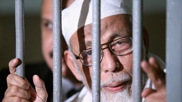 Radical cleric Abu Bakar Bashir is seen behind bars before his hearing verdict at the South Jakarta District Court in 2011.