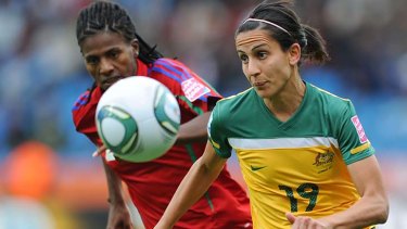 Equatorial Guinea defender Bruna, left, vies for the ball with Australia striker Leena Khamis