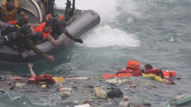 Rescuers reach out for the drowning asylum-seekers.